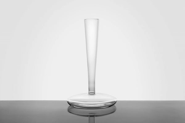 tall, thin clear glass vase with a flat, wide base