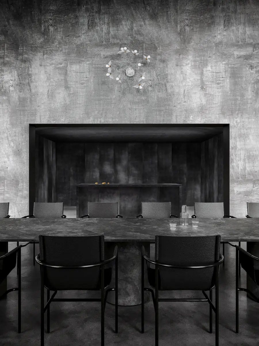 industrial dining room with a stone table and minimalist black leather chairs, arched windows