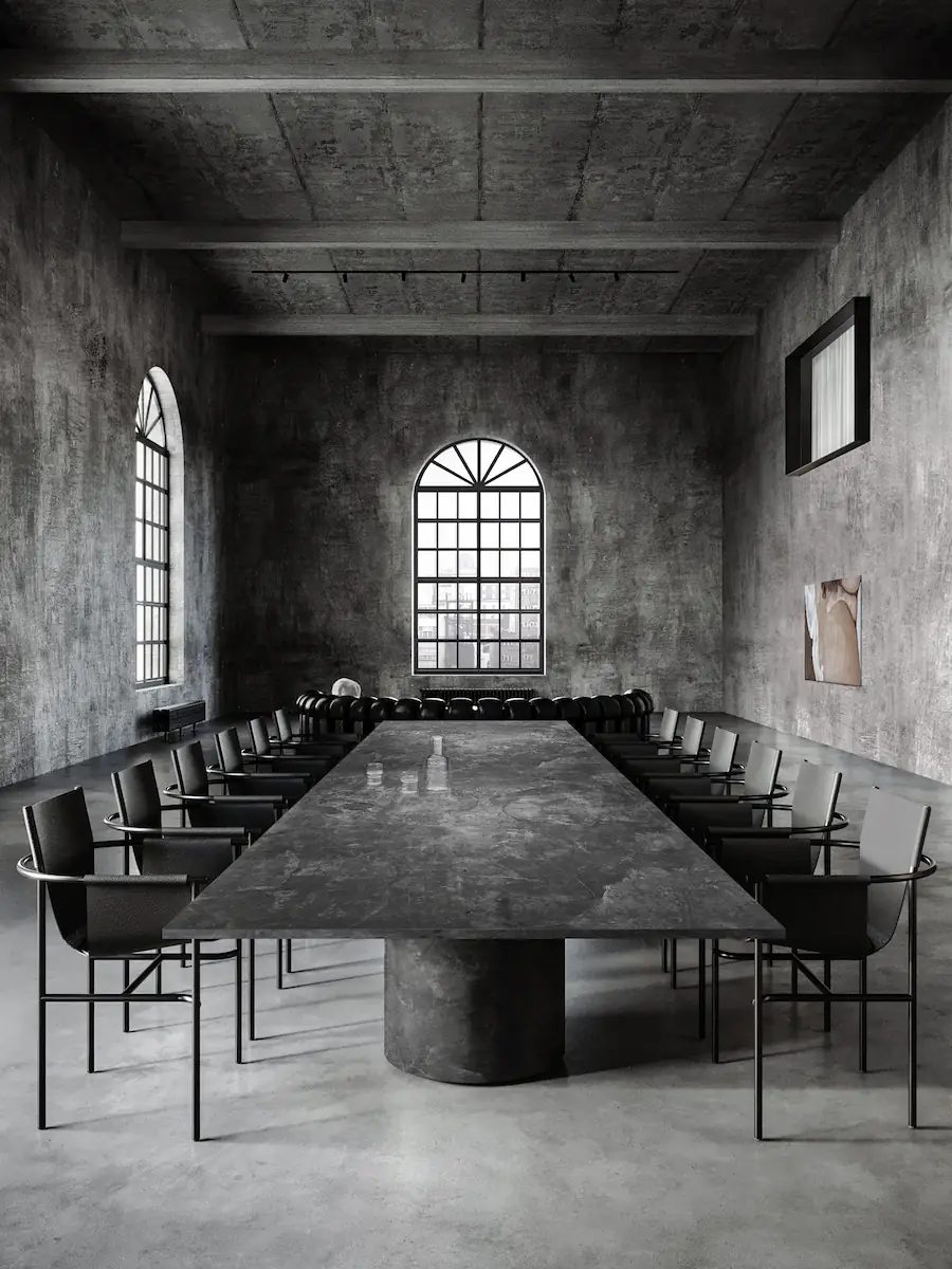 dining room with a modern black metal kitchen in the background and a surrealist wall lamp