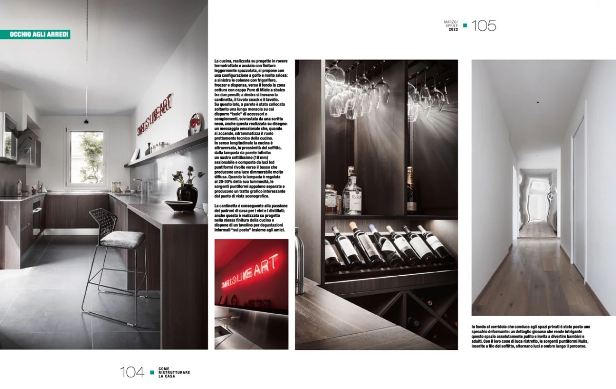 page from Come Ristrutturare la Casa April 2022, linear kitchen and wine cellar of the Bologna penthouse with neon detail