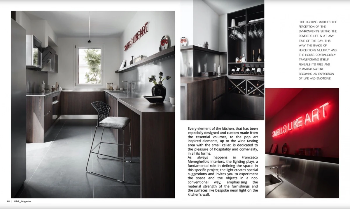 page from G&G Magazine: kitchen with stainless-steel worktops and the neon sign “SMELLS LIKE ART” in the Contemporary Penthouse in Bologna