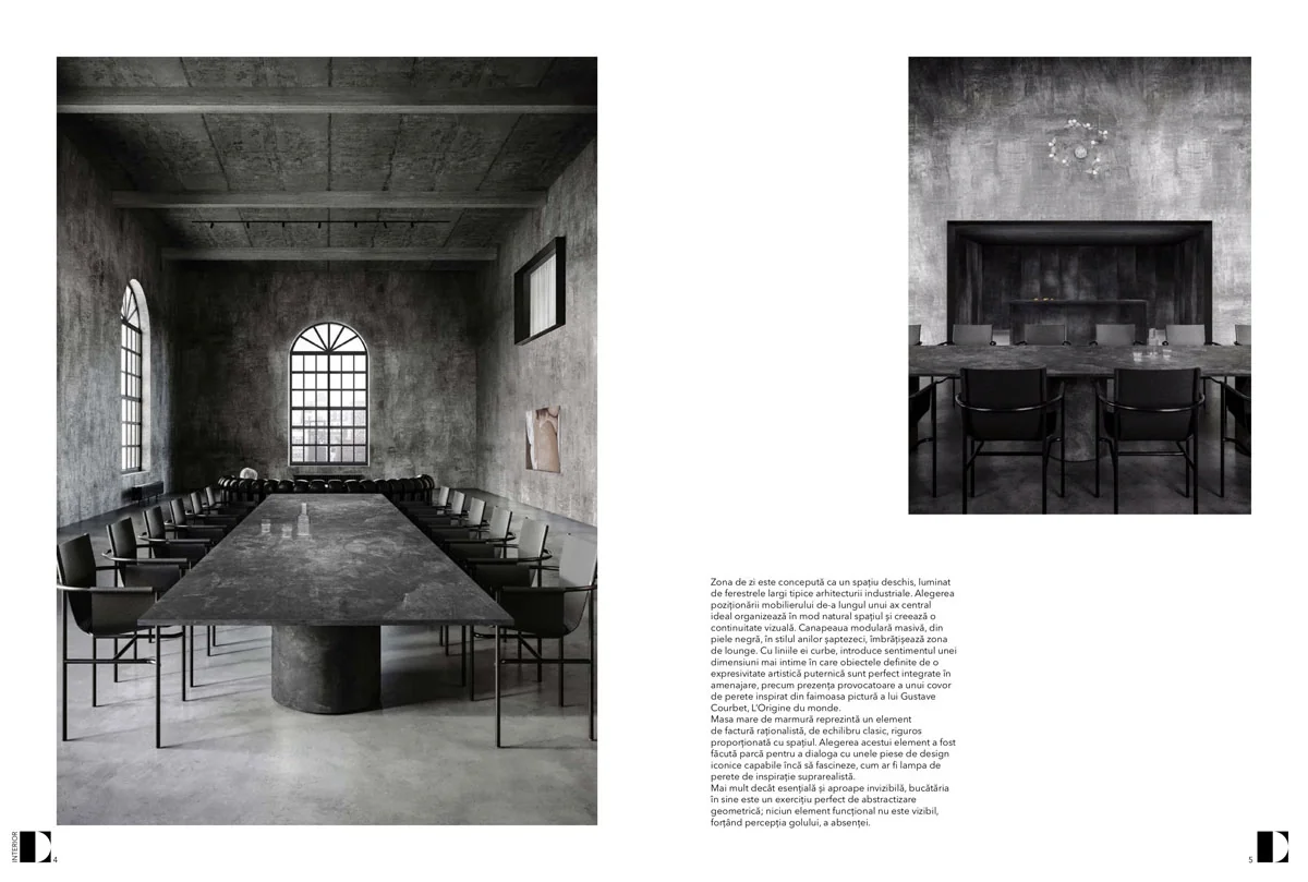 dining room in the London loft with a monolithic table, dark chairs and arched windows