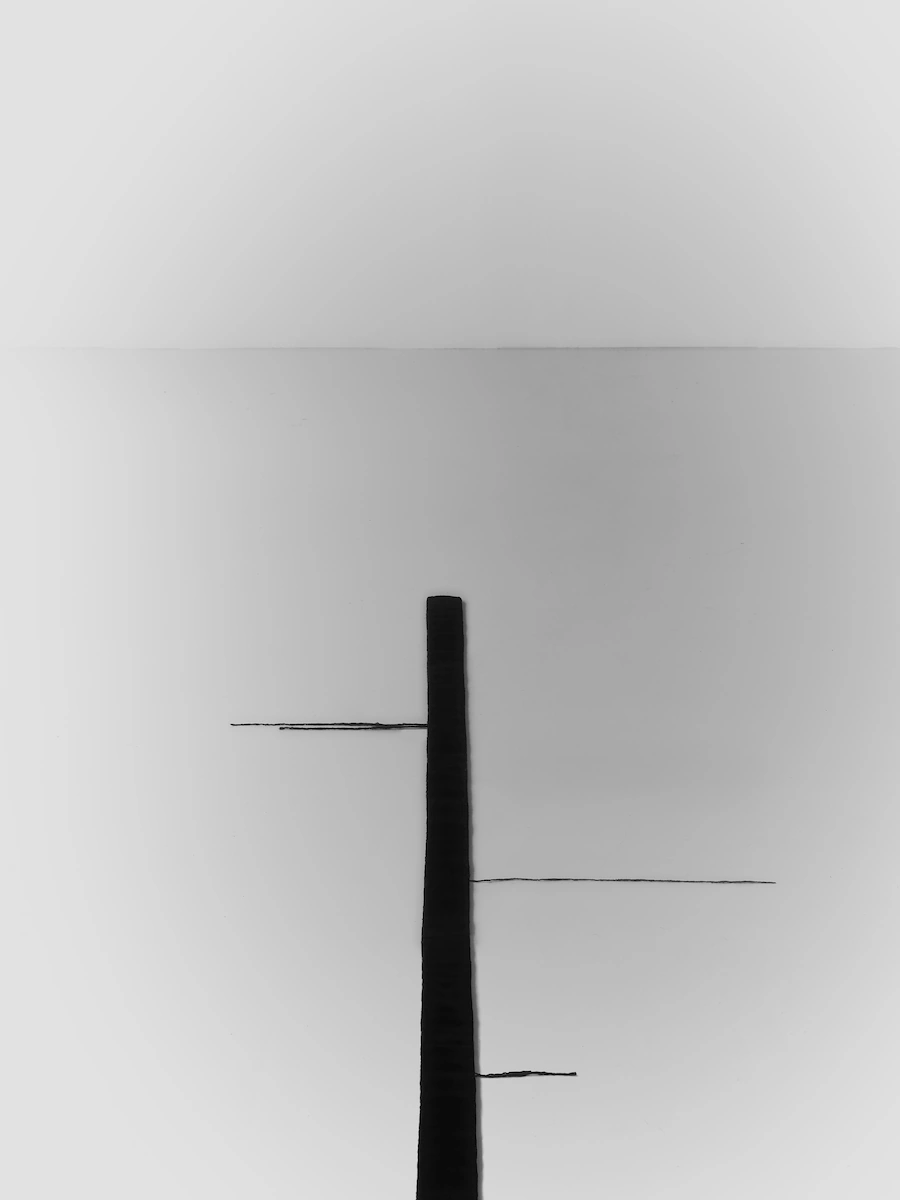 dettaglio di mensola con accessori bagno di lusso e asciugamani neri su parete grigia