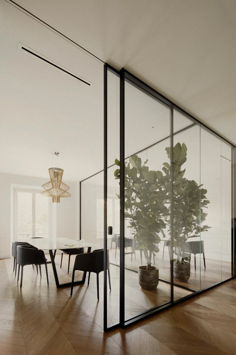 sala riunioni moderna con pareti divisorie in vetro, tavolo in marmo bianco e sedie in pelle nera, grande pianta decorativa